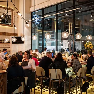 a large group of people sitting at a bar
