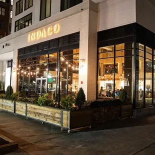 the outside of a coffee shop at night