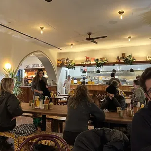 people sitting at tables in a restaurant