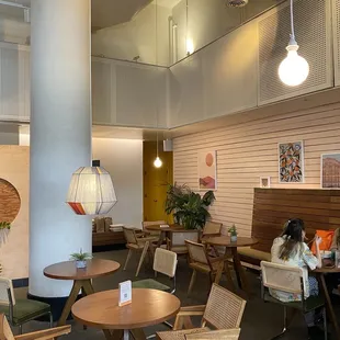 a woman sitting at a table in a restaurant