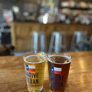 two glasses of beer on a table