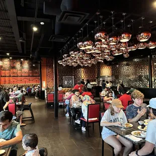 a large group of people eating in a restaurant