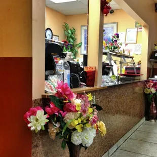 a vase of flowers in front of a counter