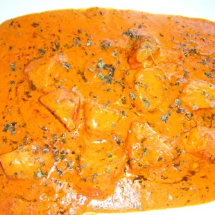 a plate of curry with shrimp