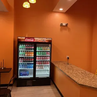 a refridgerator with soda and soft drinks