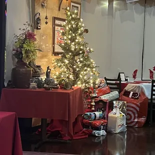 a christmas tree in the corner of a restaurant