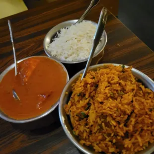 a bowl of rice and two bowls of curry