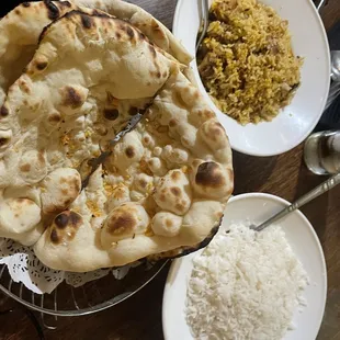 a plate of naan bread and a bowl of rice