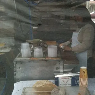 a man preparing food in a stall