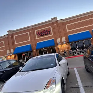 cars parked in front of a restaurant