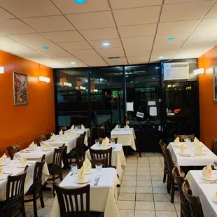 a dining room with white tablecloths and white tablecloths