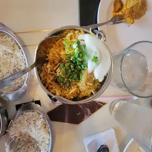 a bowl of rice and other dishes on a table