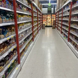 Long, wide aisles. Signs note aisle&apos;s inventory. L-snacks, R-cookies, pastries, bakes..