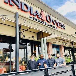 three men standing outside