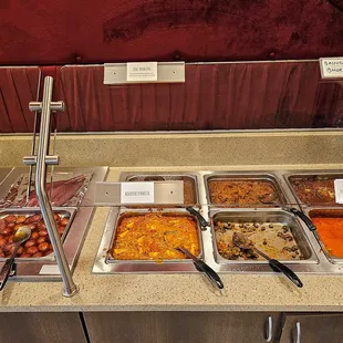 6 the center of the left table.  Zoom in to see the dish names lower glass and the top of the glass.