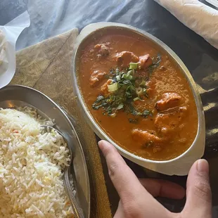 a person's hand reaching for a plate of food