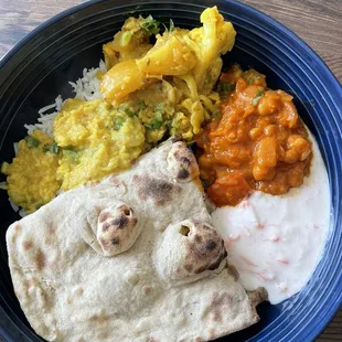 Dal tarka, aloo gobi, Chana masala, rice, tandoori roti and raita