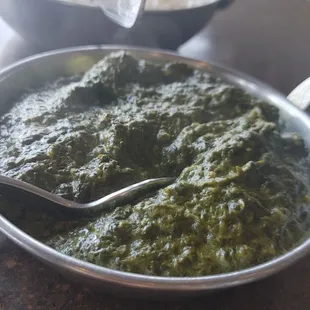 a bowl of green curry and a bowl of rice