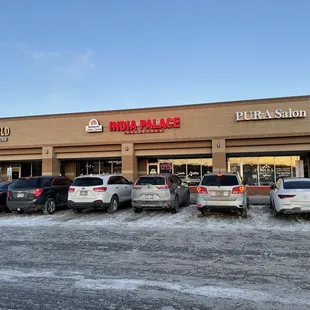 a row of cars parked in front of a restaurant