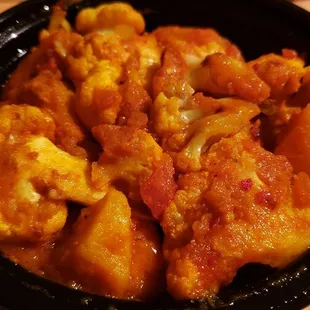 Aloo gobi ($12), vegan by default. Not bad, not amazing. The channa, dal, and vegetable curry are better.