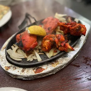 Tandoori Chicken \\ 4 pieces for $9.95 \\ comes out on sizzling fajitas plate