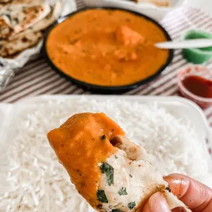 a hand holding a piece of bread