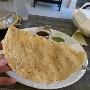Pappadum.  Chickpea crisps (I think) so good dipped in the chutneys (seen on the plate).