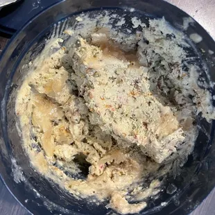 a bowl of mashed food with a spoon