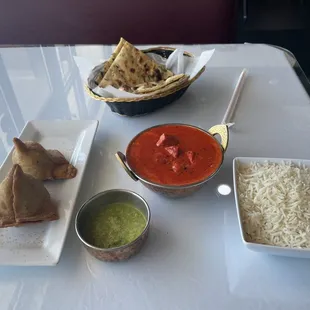 Vegetable samosas with mint chutney and butter chicken with a side of garlic naan