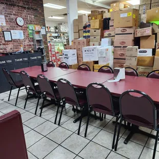 a long table with chairs and boxes