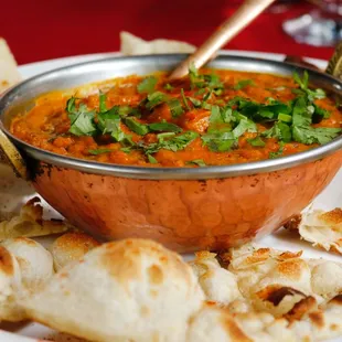 a bowl of soup and pita bread