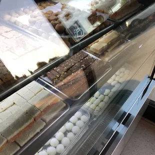 a display case with a variety of desserts