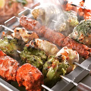 skewers being cooked on a grill