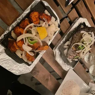 two trays of food on a table