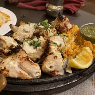 Reshmi chicken. (thought it comes in paste but it was bland) Tender, grilled, very unsalted though. Came w/ some biryani &amp; onion, cabbage.