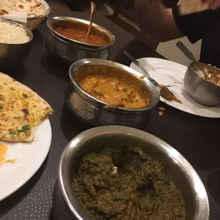 Lamb Vindaloo, vegetable korma and saag paneer with garlic naan