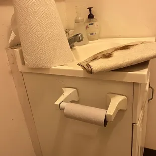a roll of toilet paper on a cabinet