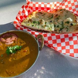a bowl of soup and a slice of pizza