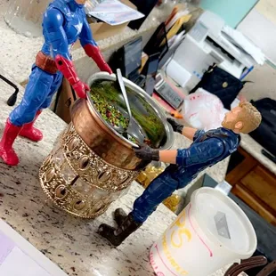 two figurines in a kitchen