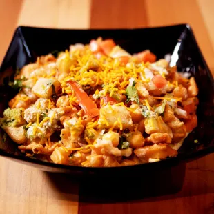 a bowl of food on a wooden table