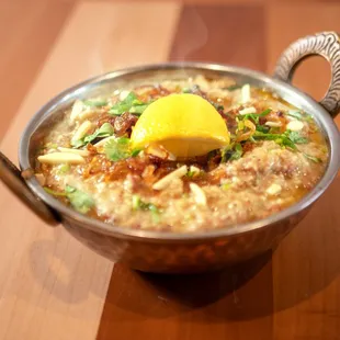a bowl of food on a wooden table