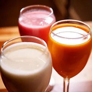 a glass of milk and a glass of juice