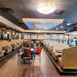 a restaurant with tables and booths