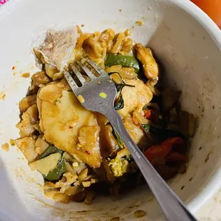 a bowl of food with a fork in it
