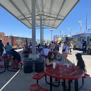 a group of people at a food truck park