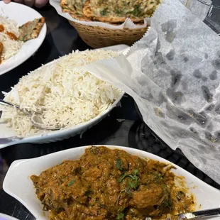 Lamb saag, Chicken Jalfrezi, garlic naan, Keema Nan, rice and a side of French fries.