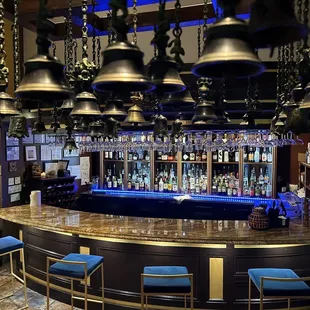 a bar with bells hanging from the ceiling