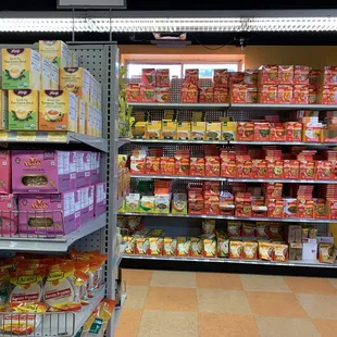 The shelves are full of grocery, beauty products and spices.