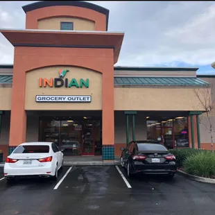 two cars parked in front of the store