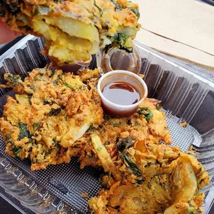 a person taking a piece of food out of a plastic container